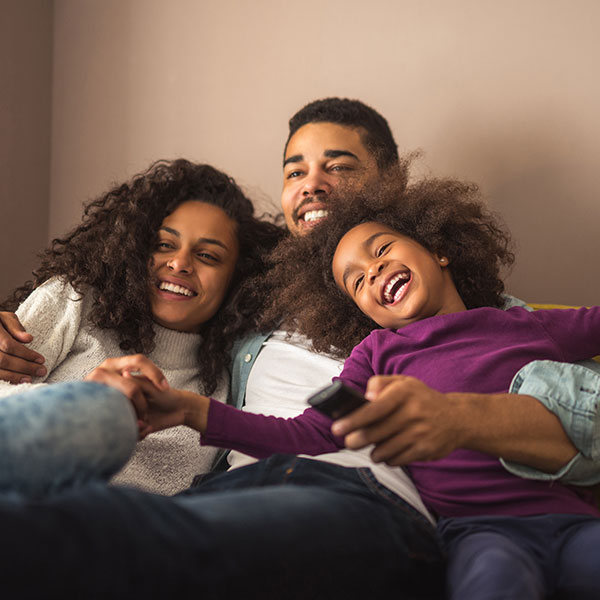 FamilyLaughingonCouch Family laughing on a couch